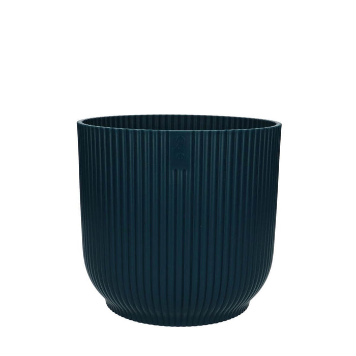 Vibes pot in soft blue hue with unique ribbed texture, perfect for displaying vibrant foliage.